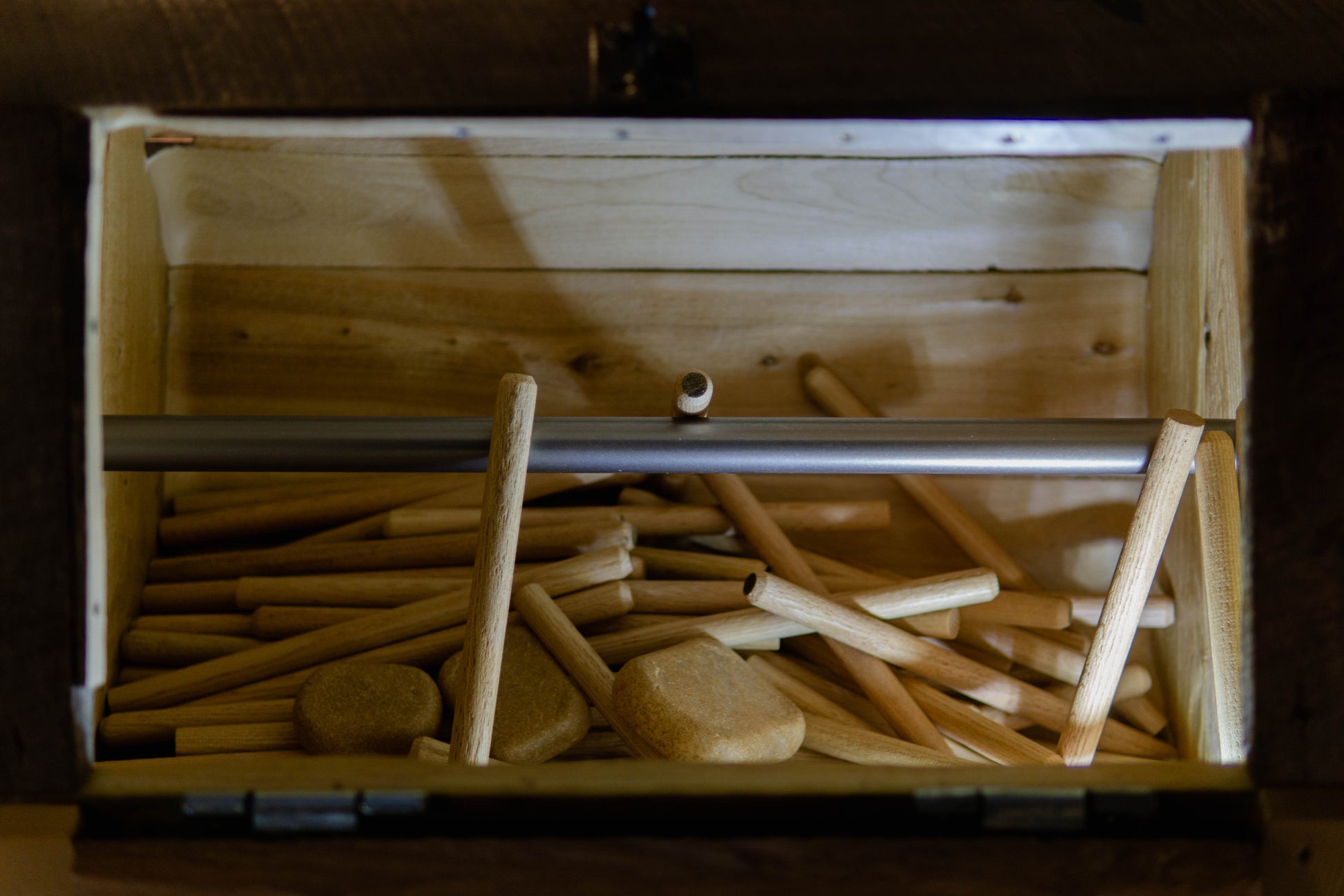 Tapered pegs in a tumbler for timber frames